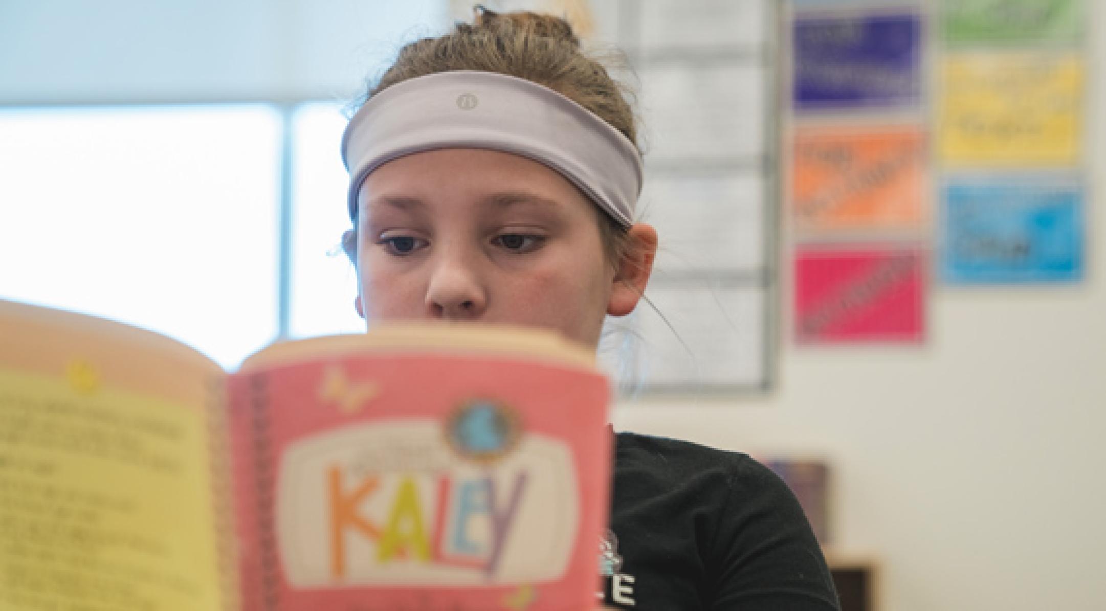 Student reading from book