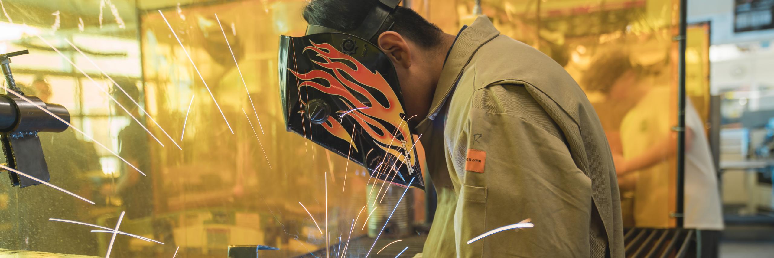A student welds at a Poudre School District High School.